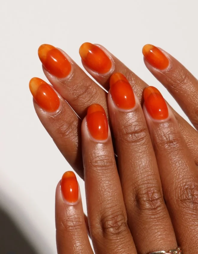 Amber jelly nails with translucent warm orange glossy autumn manicure.