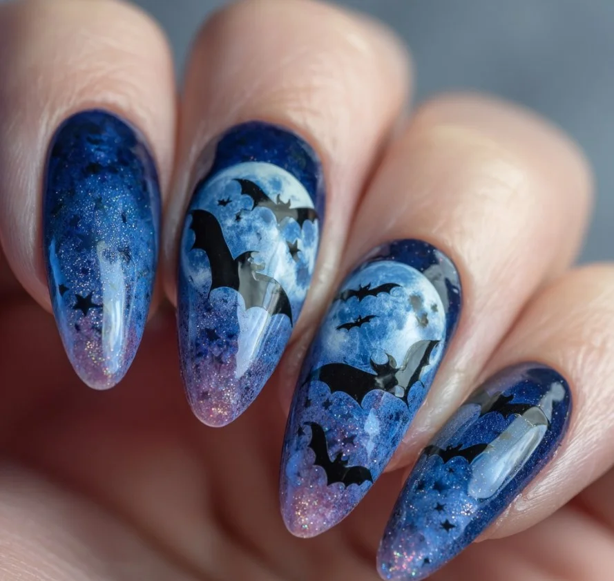 Bat silhouette Halloween nails with flying bats against a moonlit gray background.