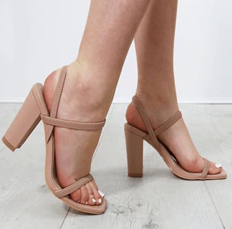 Beige heels styled with a sage green dress