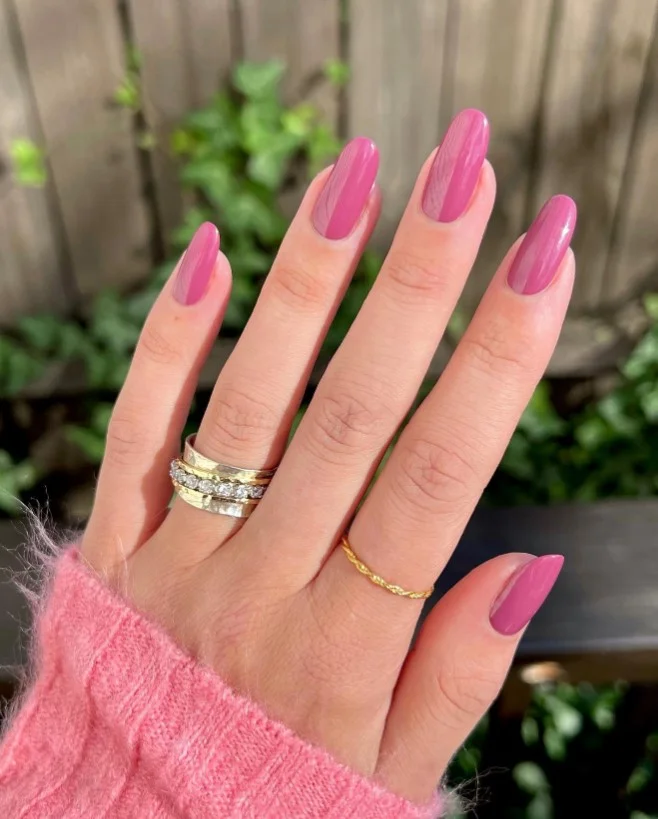 Berry pink nails on tan skin with a fresh, feminine finish.
