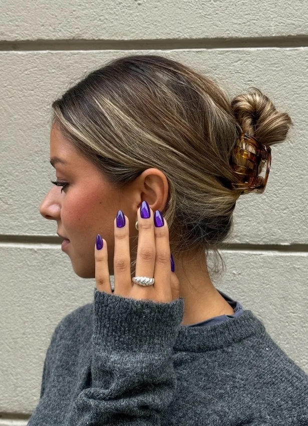 Cat-eye amethyst purple nails with magnetic shimmer and gemstone-inspired finish.