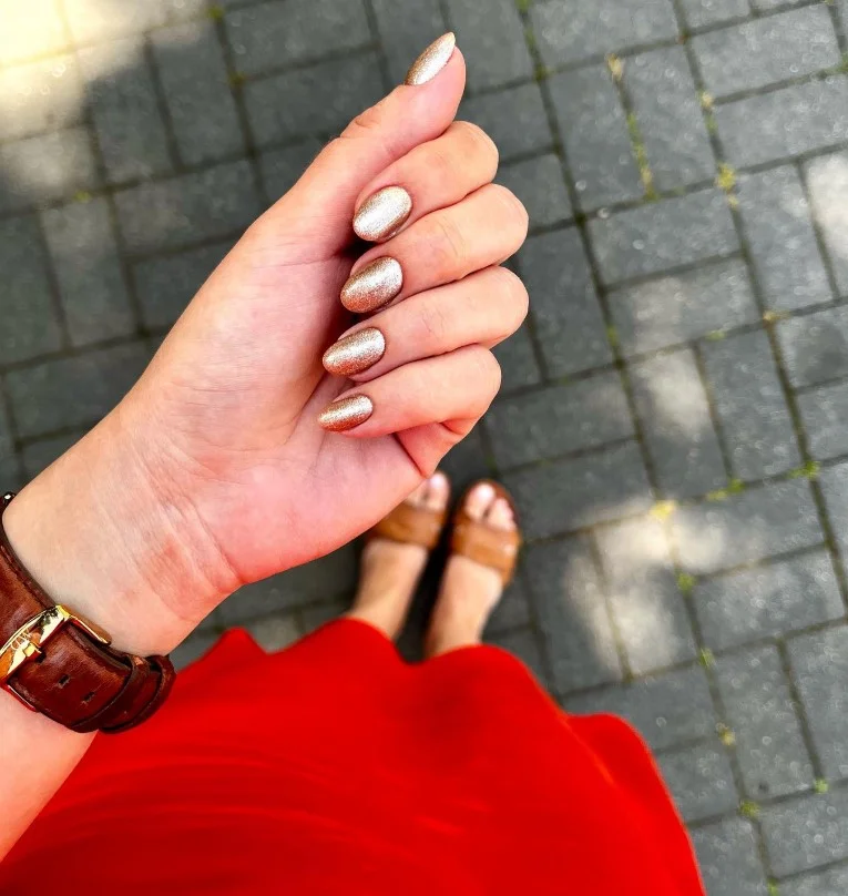 Champagne gold nails styled with a purple party dress