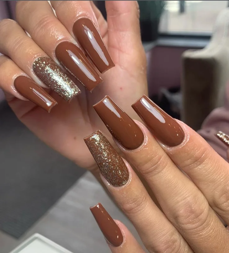Chocolate brown acrylic nails with rich glossy finish on coffin-shaped nails.