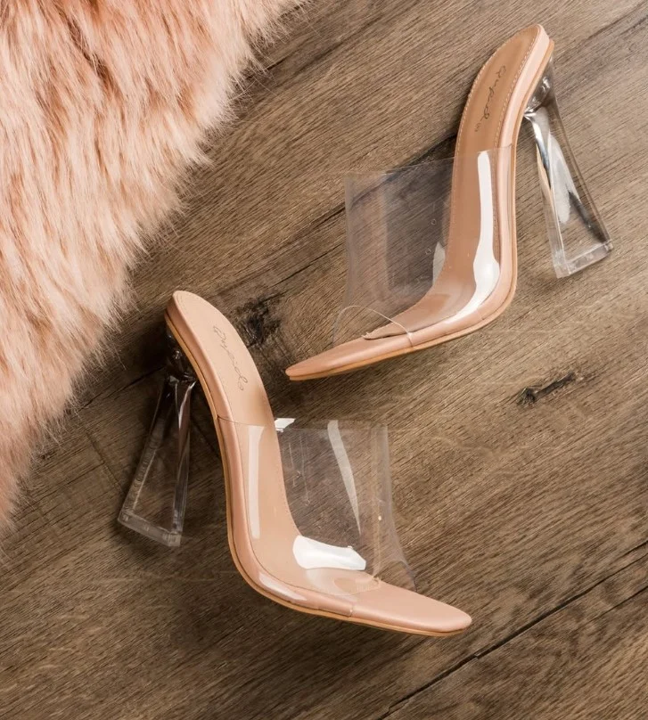 Clear heels paired with a brown maxi dress