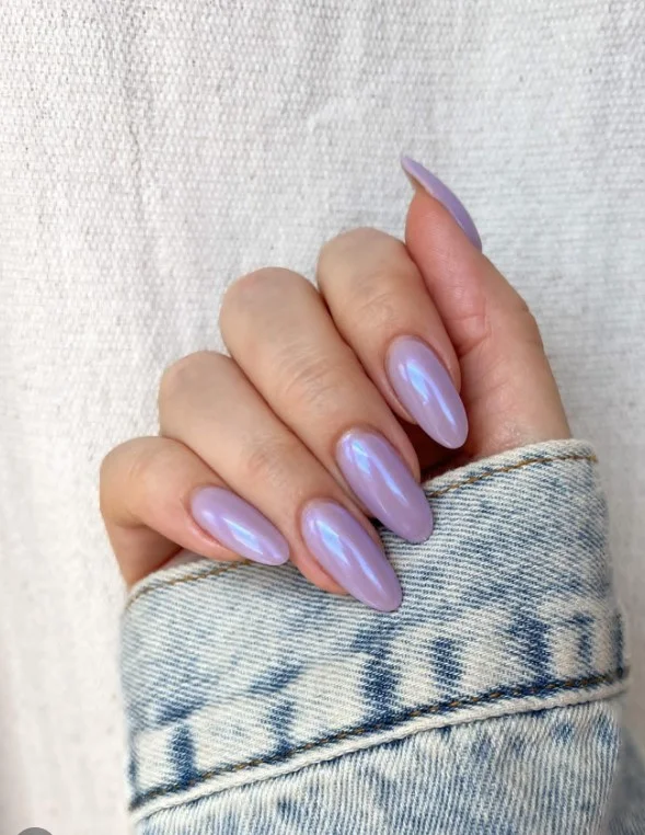 Cool lavender manicure on fair skin with a glossy finish