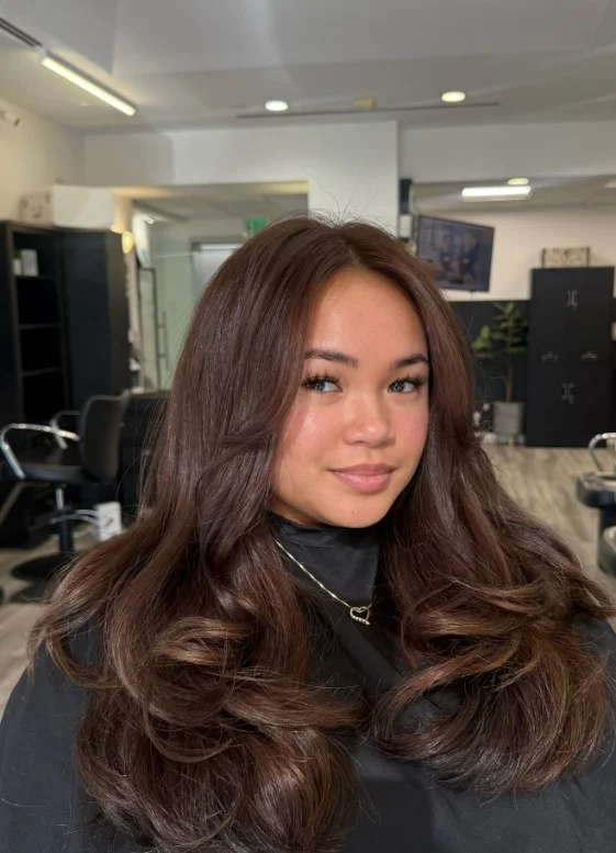 Cool mocha brown hair with healthy shine on sensitive skin tone.