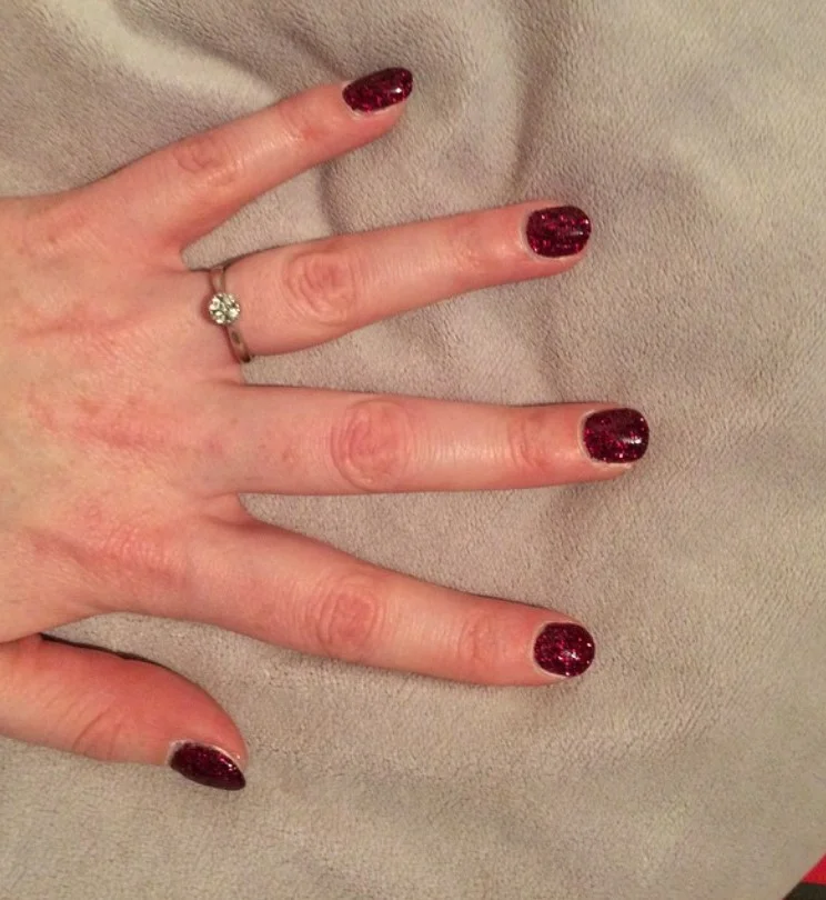 Cranberry glitter accent nails with sparkling deep red fall manicure.
