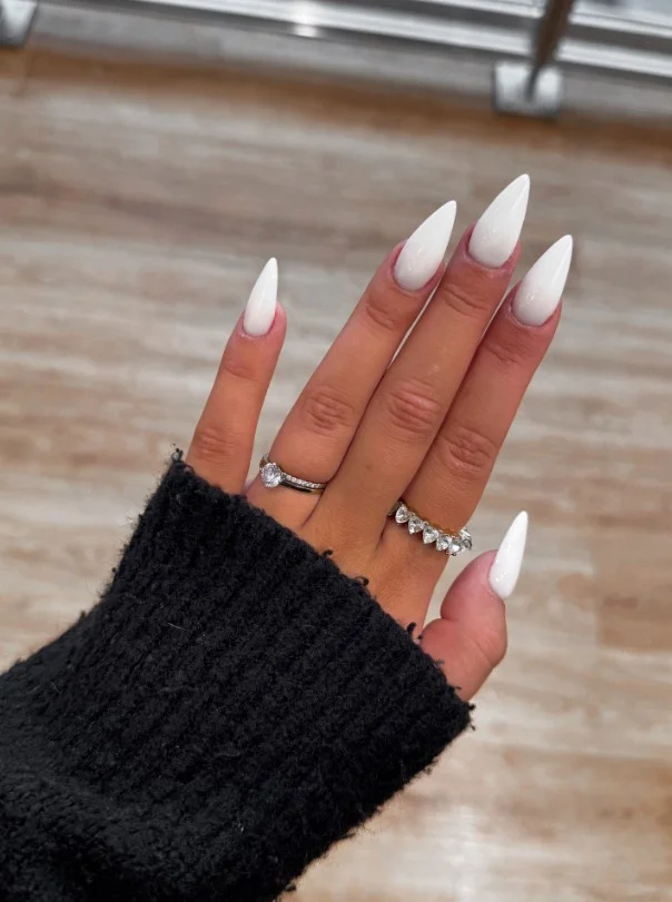 Creamy white nails on tan skin with a clean minimalist style.