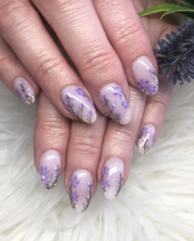 Cute lavender floral nails with fine vine details on soft pastel purple polish.