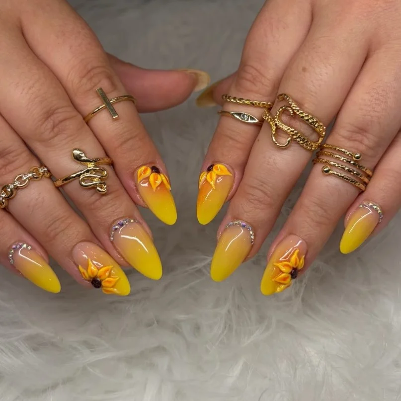 Cute sunflower accent nail design with bright yellow petals on nude glossy nails.