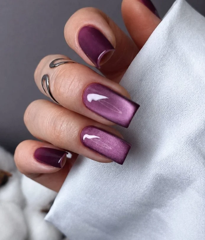 Deep plum velvet cat-eye nails with magnetic shimmer and luxurious finish.