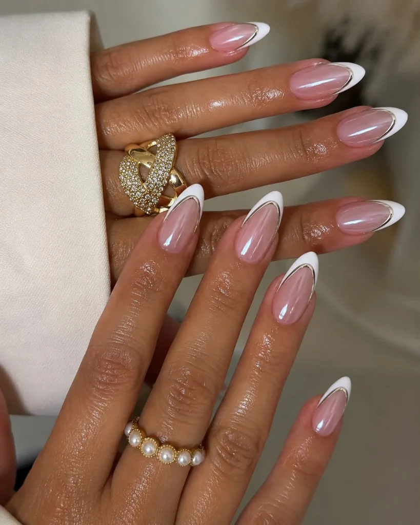 French tip acrylic nails with metallic chrome outline on nude glossy base.