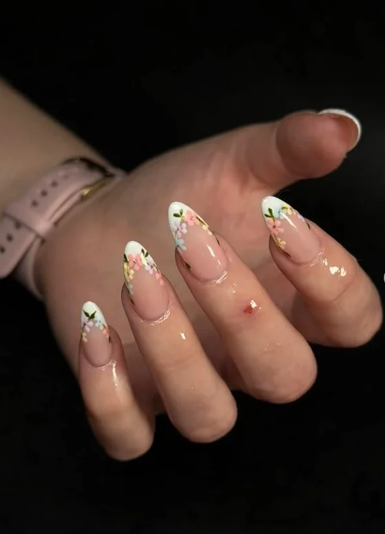 French tip manicure featuring delicate micro flower accents on natural nude nails.