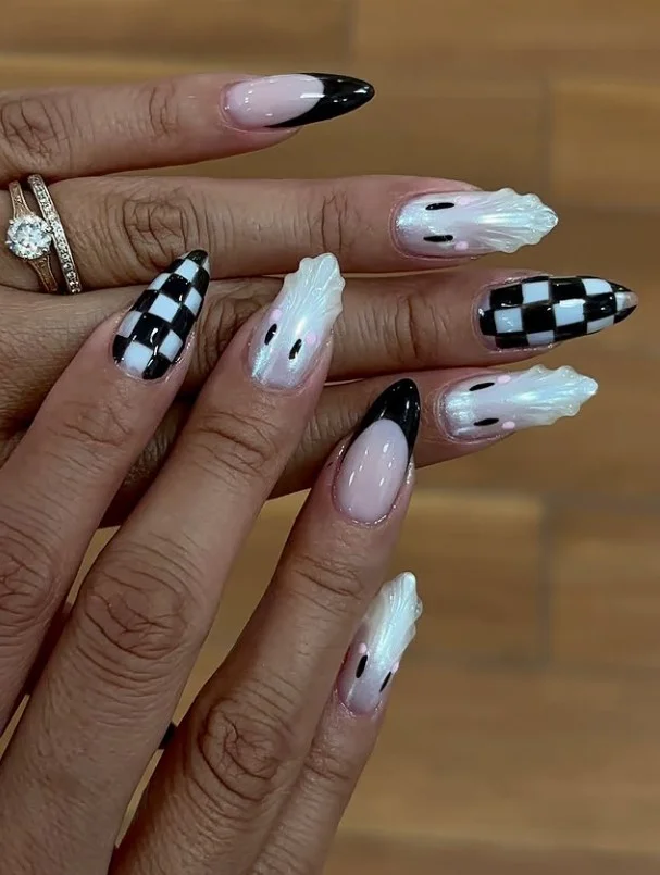 Glazed ghost chrome Halloween nails with pearly chrome finish and cute ghost details.