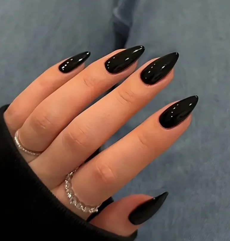 Glossy black manicure with a dark purple dress