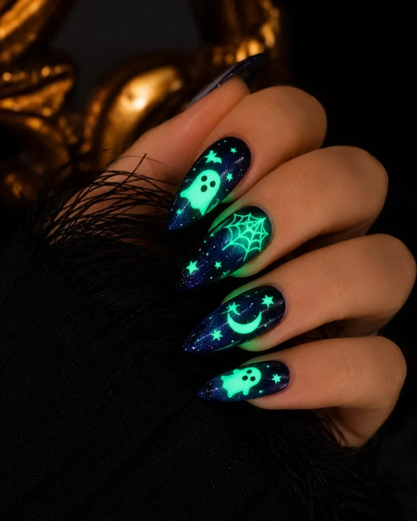 Glow in the dark ghost Halloween nails with luminous white ghost nail art.