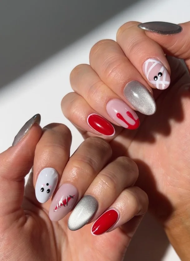 Halloween mix-and-match character nails with ghosts, pumpkins, bats, spiders, and stars.