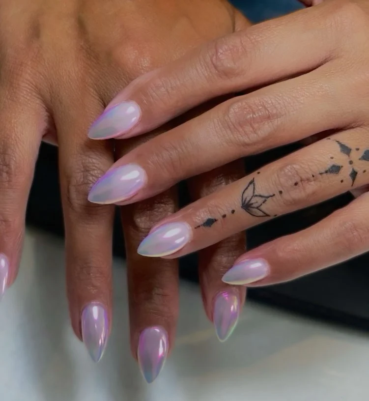 Iridescent lilac pearl nails with luminous glossy chrome finish.