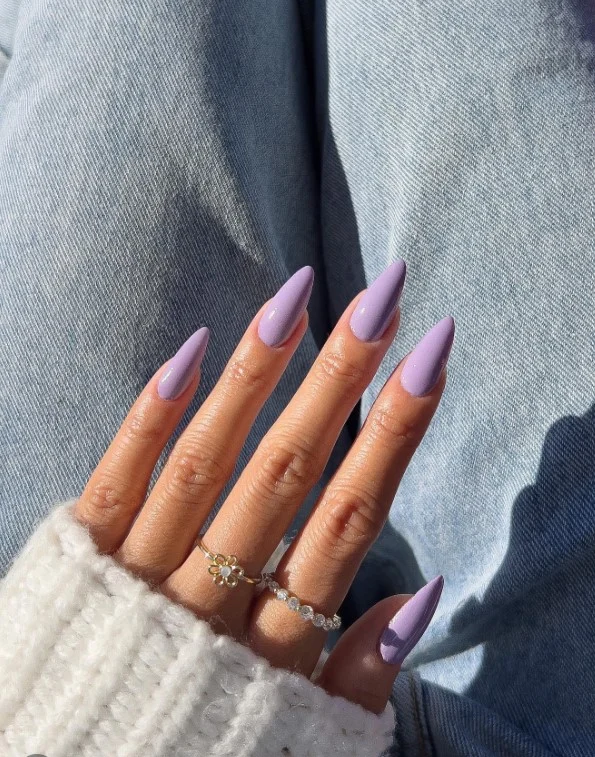 Dusty lavender nails on tan skin with a soft pastel look.