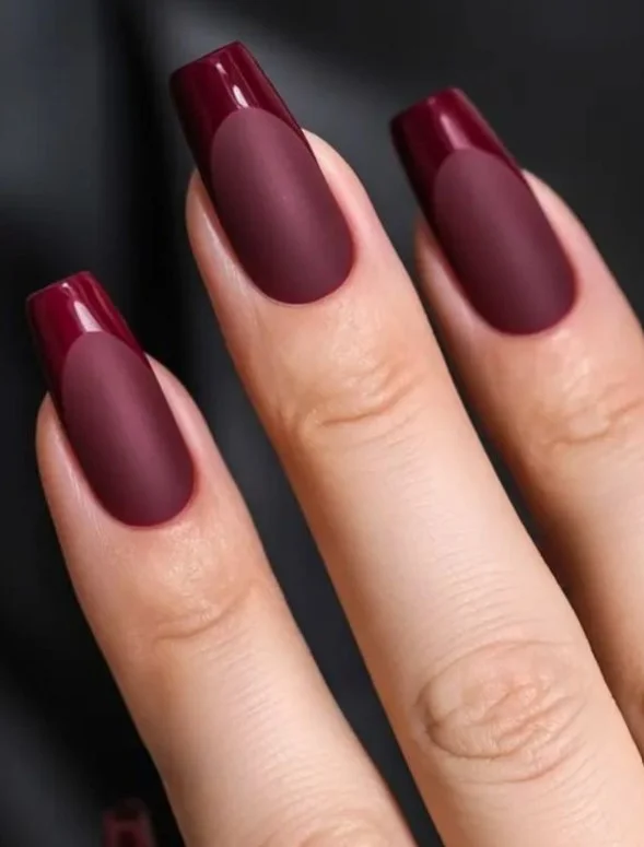Matte plum nails with glossy French tips creating modern purple nail design.