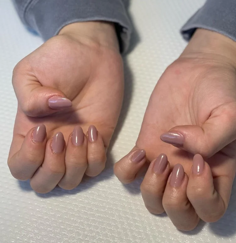 Mauve nude nails paired with a plum purple dress