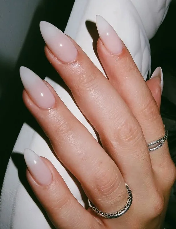 Milky white nail polish on pale skin for a clean everyday manicure