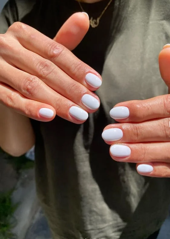Milky white short press-on nails with glossy creamy white polish.