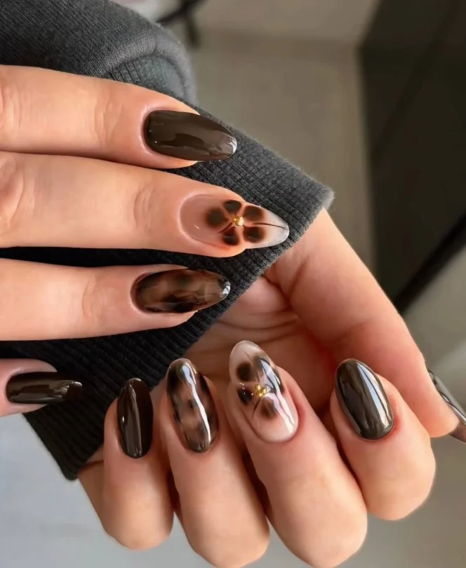 Mocha latte nails with tiny floral accents on glossy warm brown polish.