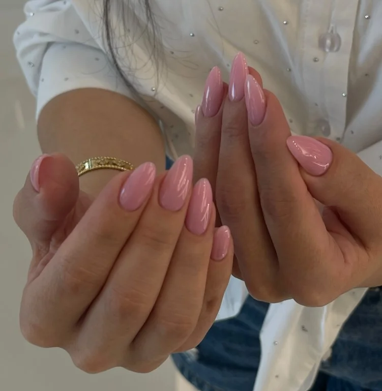 Nude pink nails paired with a purple dress for an elegant outfit