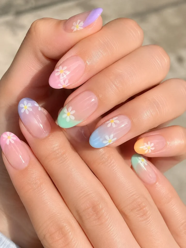 Colorful pastel daisy nail designs on a clear jelly base with glossy finish.