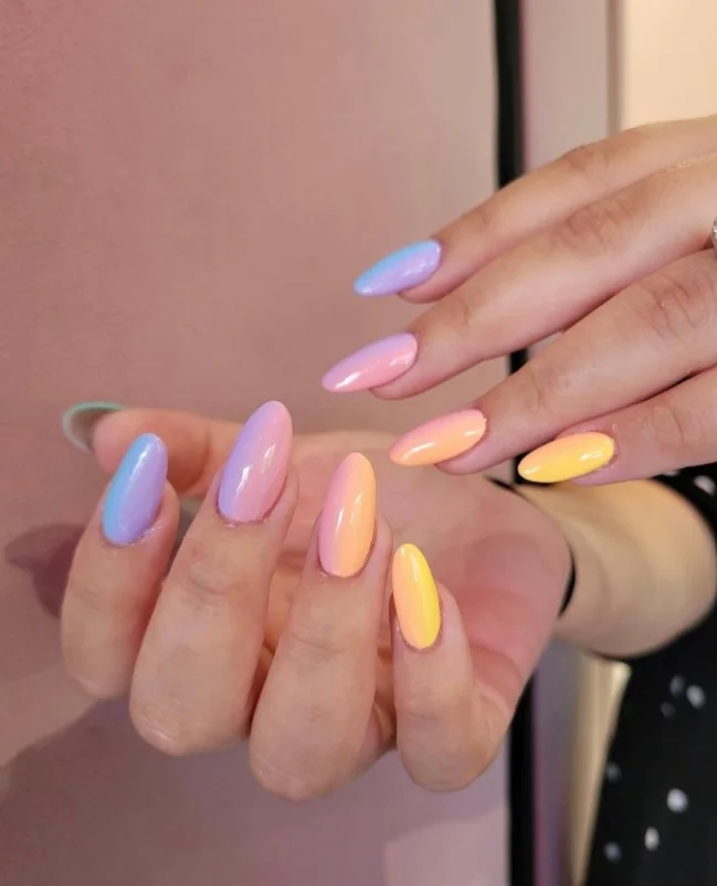 Pastel ombré acrylic nails blending soft pink, lilac, and blue shades.