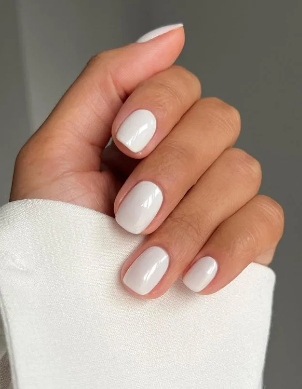 Pearl white nails for a purple wedding guest dress
