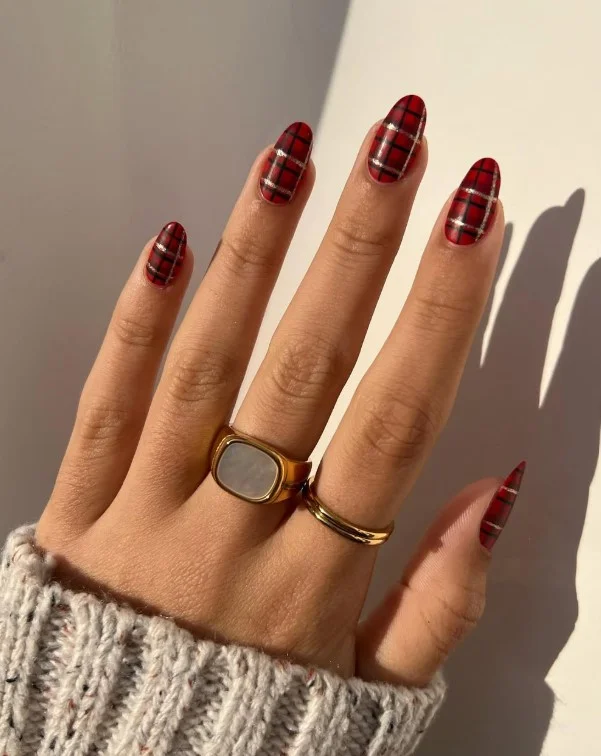 Plaid accent nails in burgundy, mustard, cream, and brown autumn colors.
