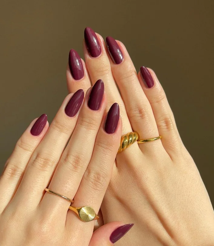Plum nail polish creating a monochrome purple dress look