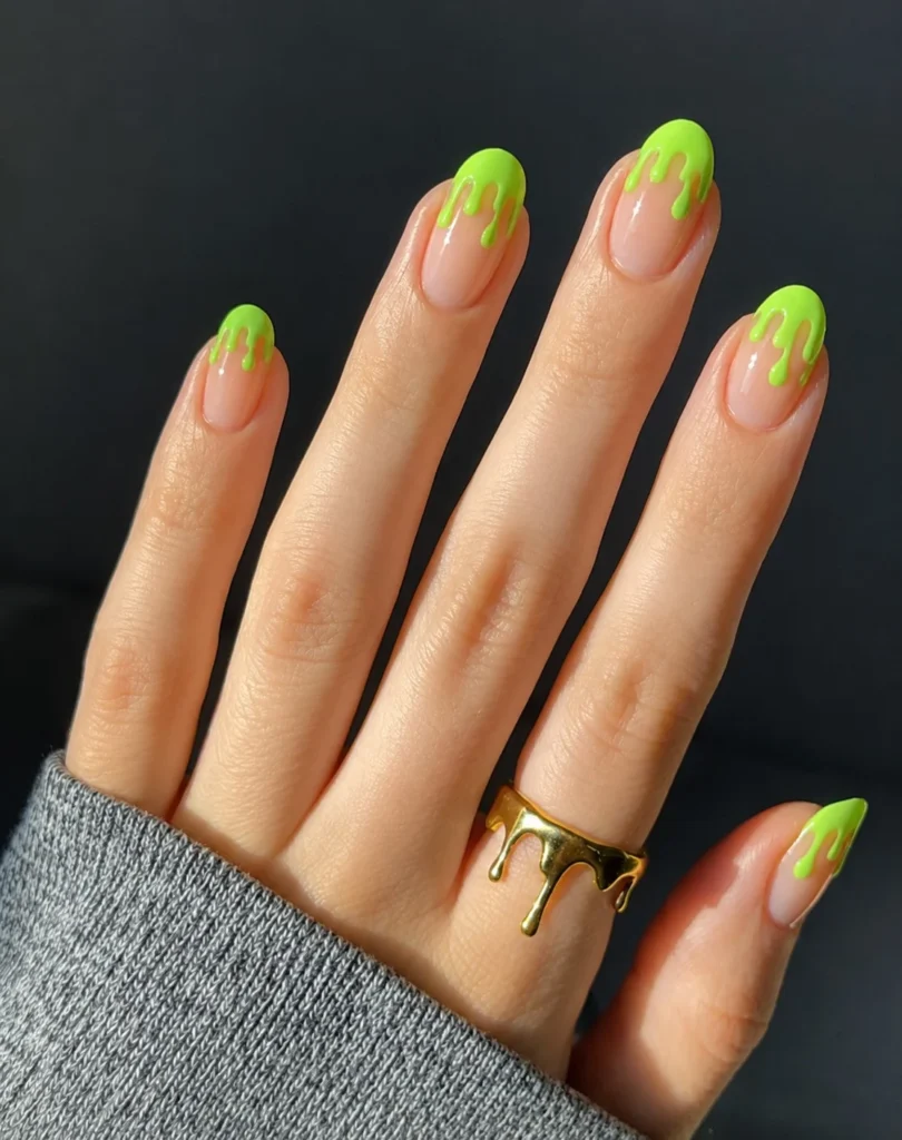 Poison green slime drip Halloween nails with glossy green dripping nail art.