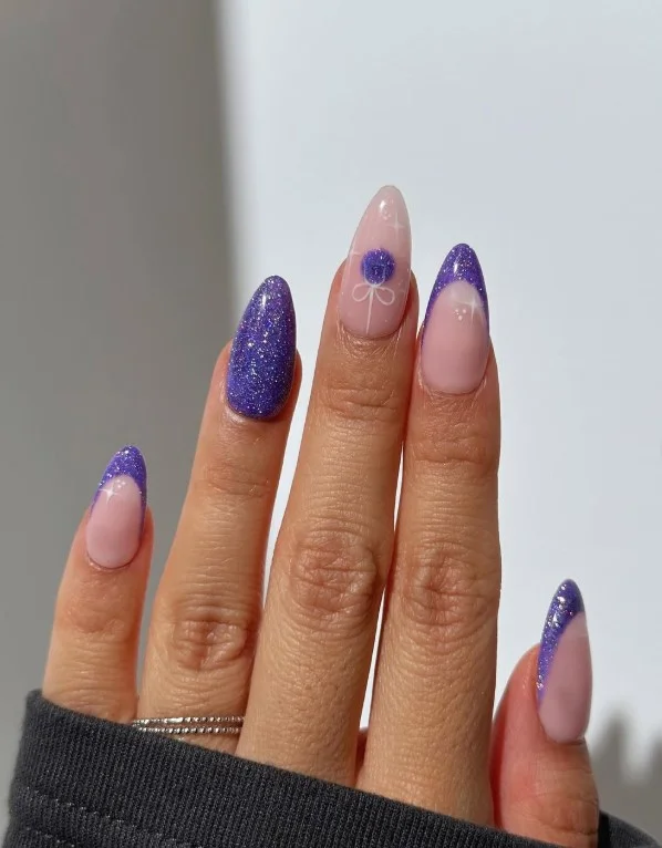 Purple glitter fade nails with sparkling gradient tips on glossy manicure.