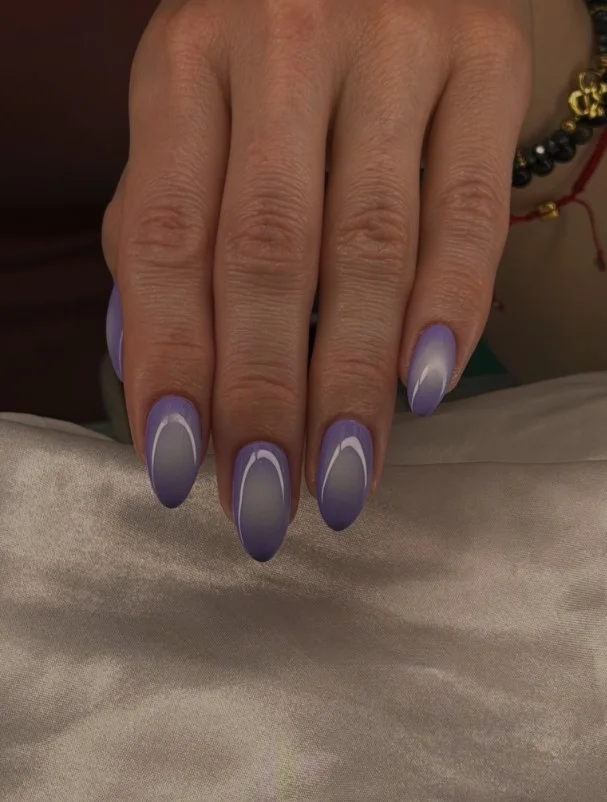 Purple ombré almond nails with seamless gradient from lilac to deep violet.