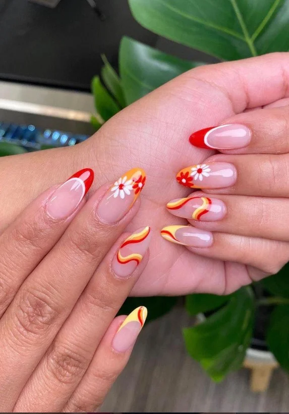 Retro '70s floral swirl nail design featuring colorful vintage-inspired flower patterns.