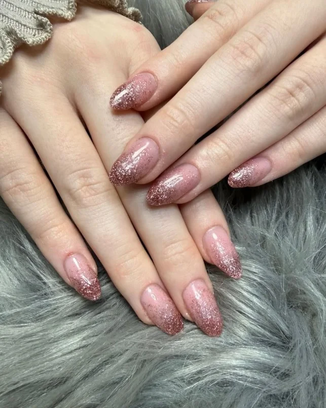 Rose gold shimmer nails on pale skin for a subtle glamorous look