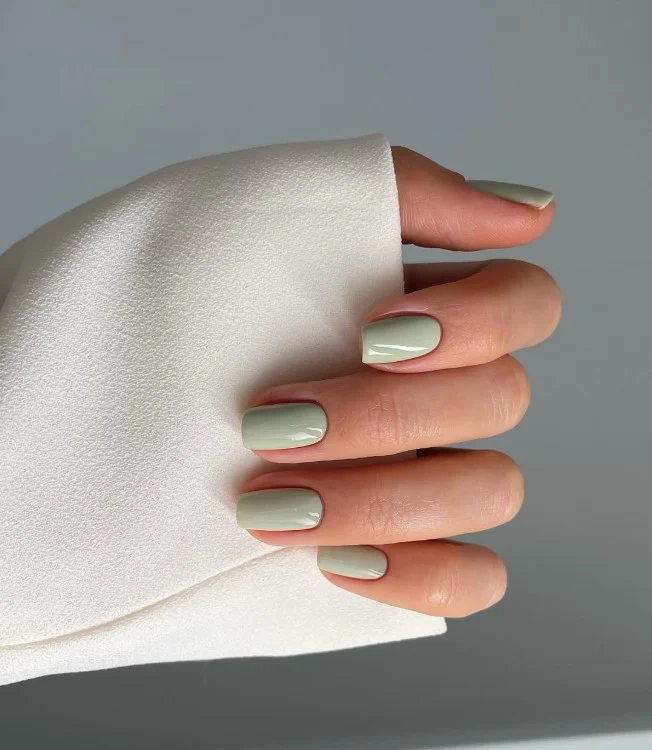 Sage green manicure for pale skin with a modern minimalist style
