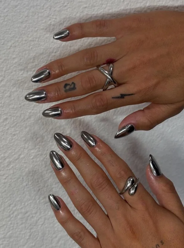 Silver chrome nails with a deep purple dress