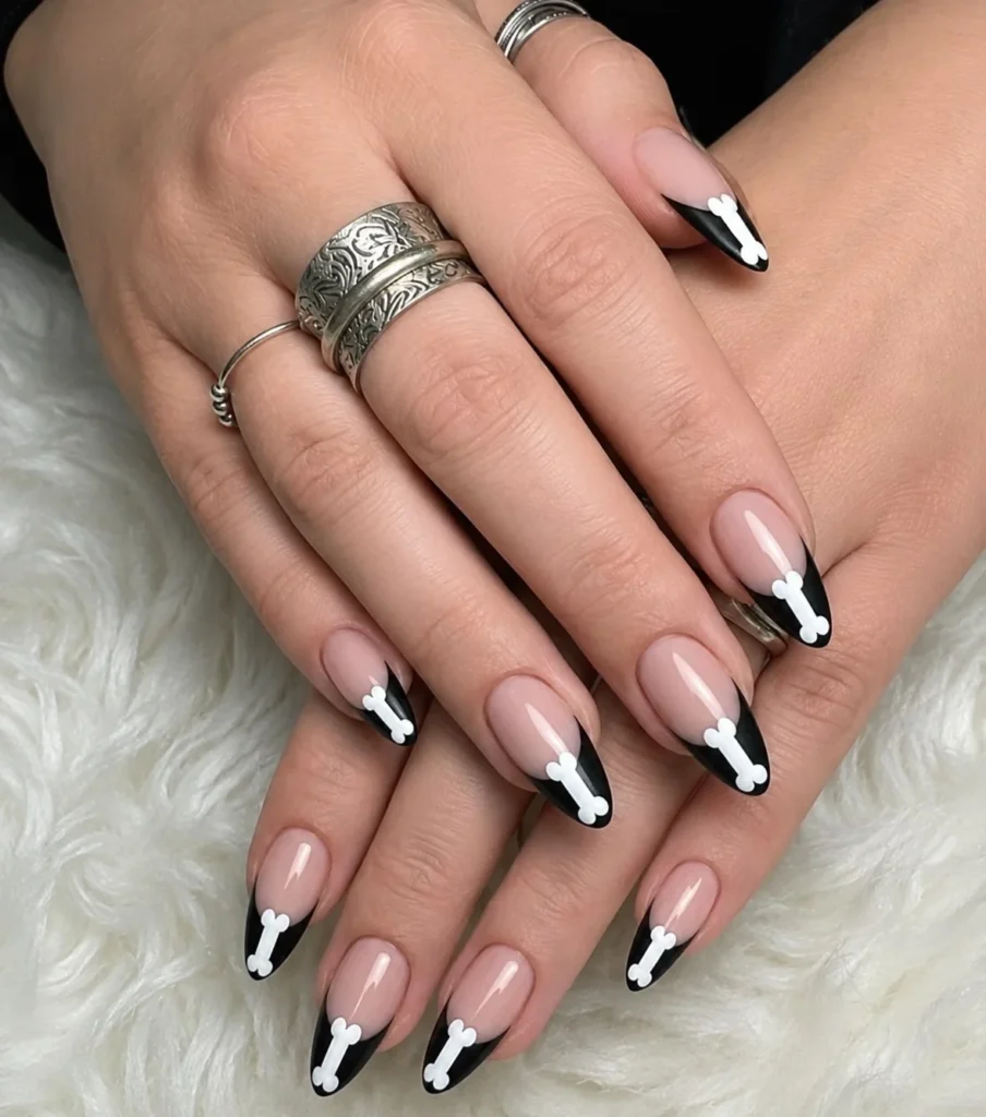 Skeleton bone French tip Halloween nails with white bone-inspired nail art.