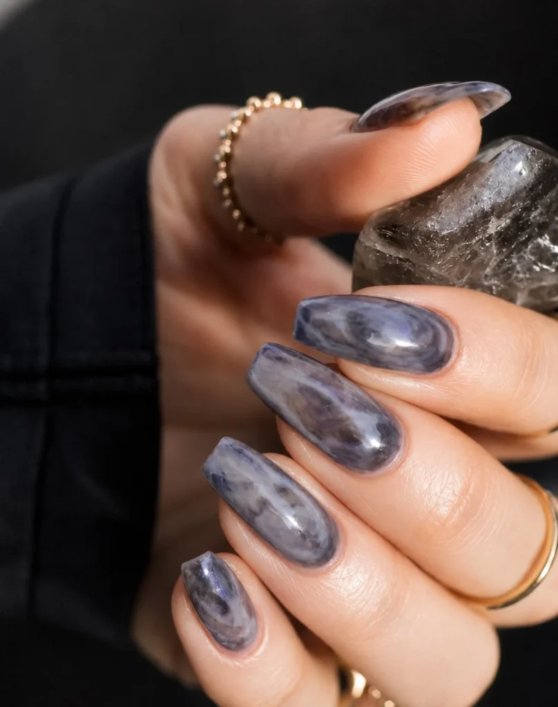 Smoky quartz marble nails with gray-brown stone effect and glossy finish.