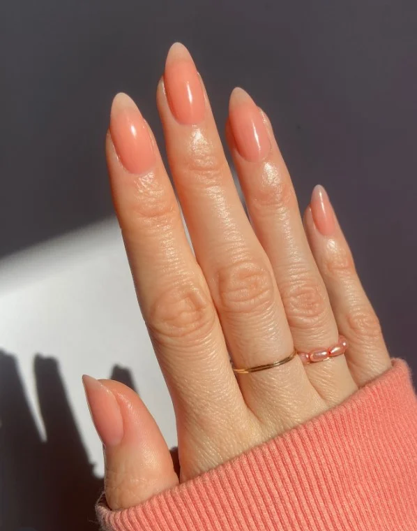 Soft peach nails complementing a lavender dress
