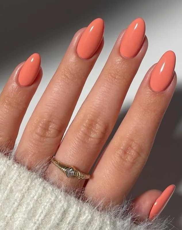 Soft peach nude manicure on pale skin for a fresh polished look