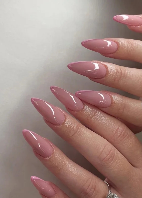 Soft pink acrylic nails with elegant glossy finish on almond-shaped nails.