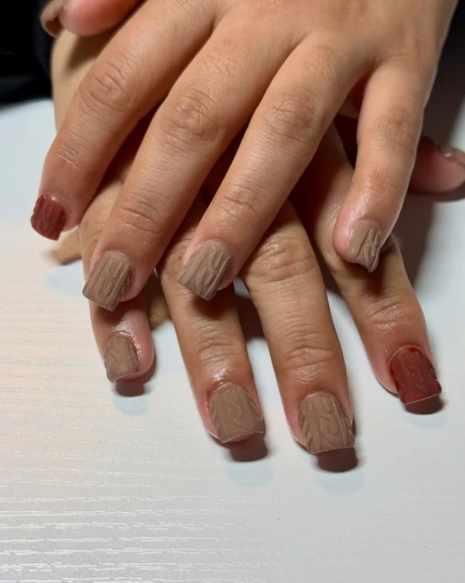 Sweater knit texture nails in cozy neutral tones with raised cable pattern.