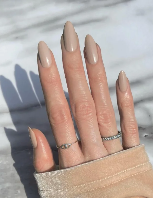 Warm taupe nails on tan skin with a simple everyday style.