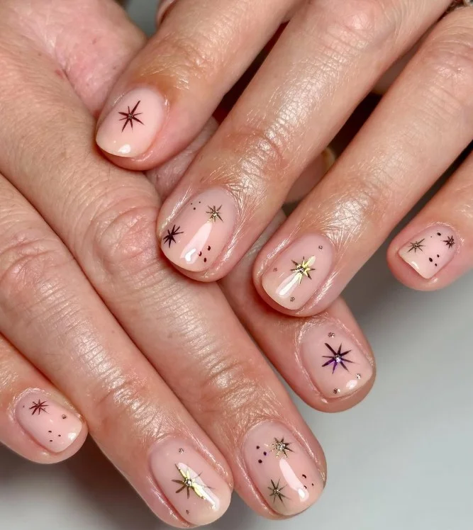 Tiny chrome star short nails with metallic silver star accents.