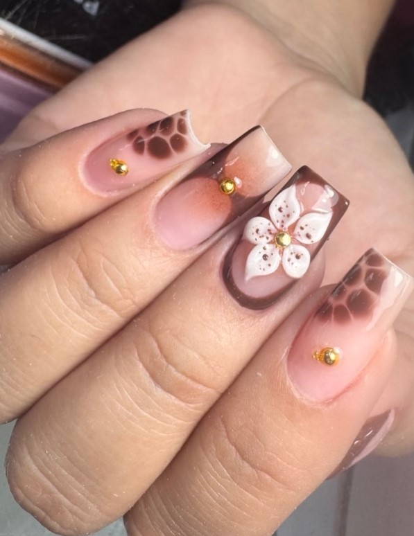 Tortoiseshell acrylic nails with layered amber and brown glossy pattern.